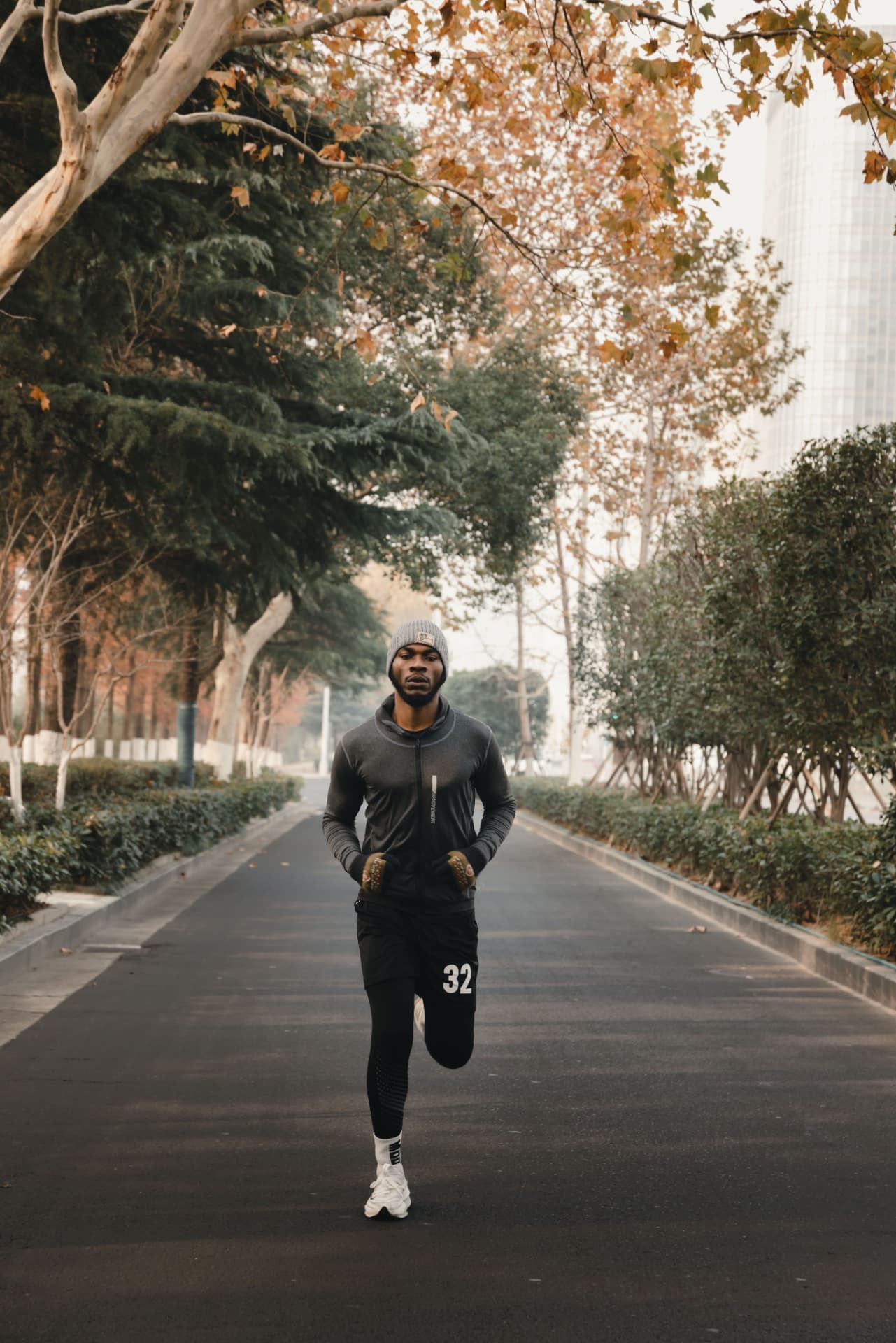 Student jogging on a sunny campus path